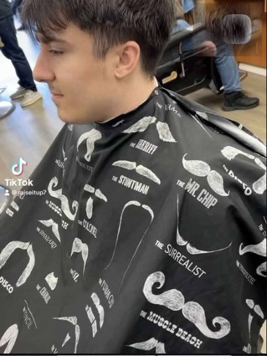 Textured fringe with a mid fade, a custom style at Plaza Barber Shop West Hempstead