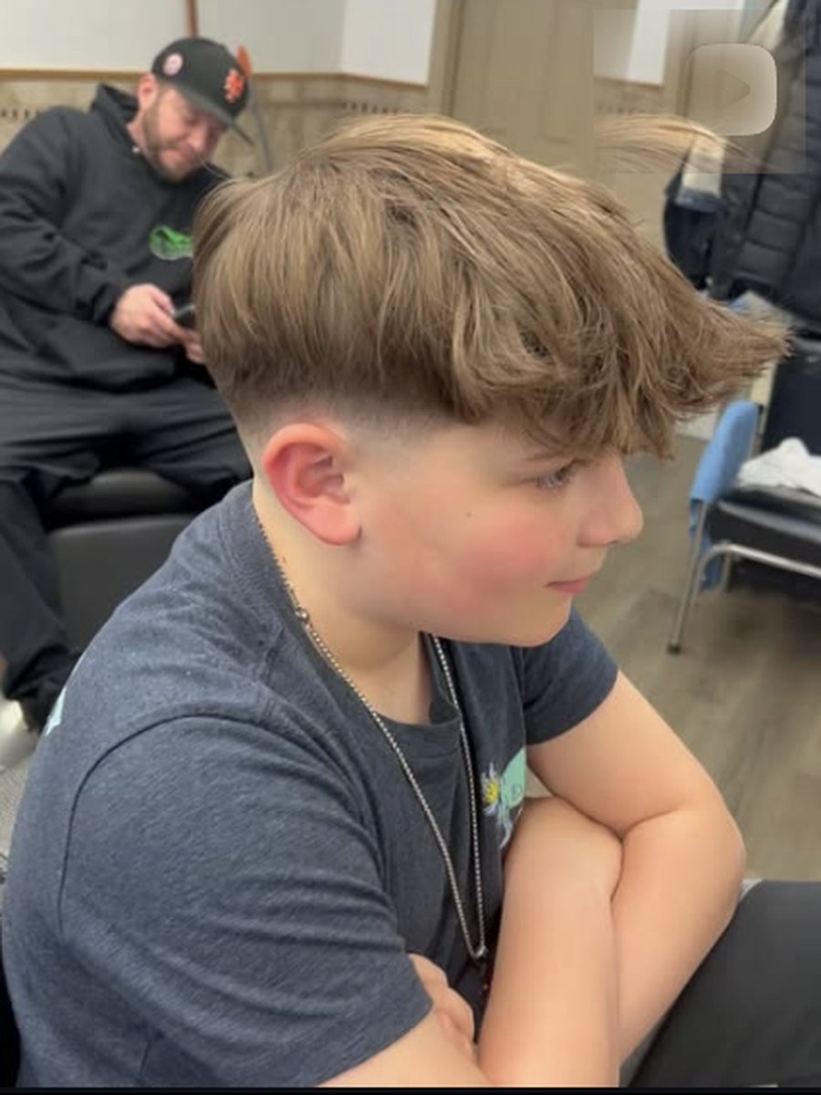 Young boy having his hair cut at the child friendly Plaza Barber Shop
