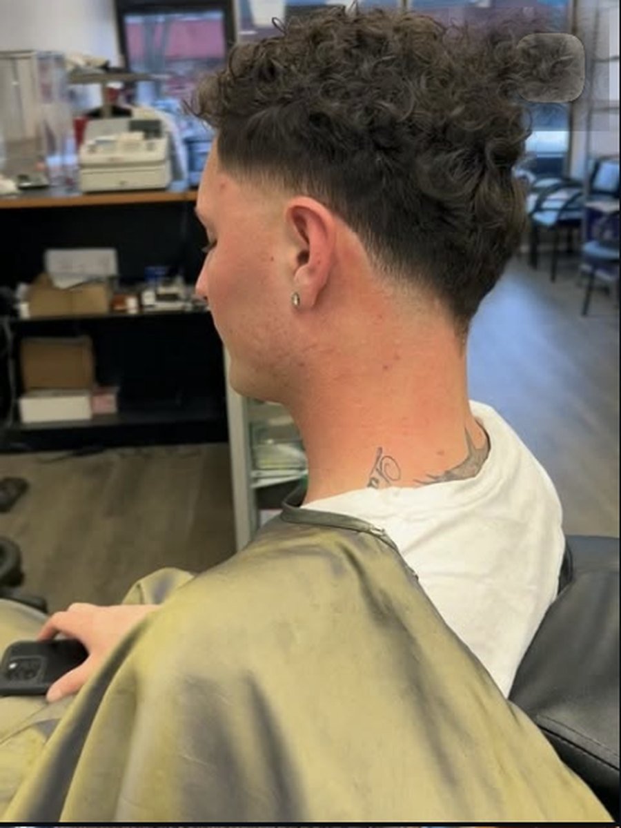 Classic side part with a scissor cut top at Plaza Barber Shop West Hempstead