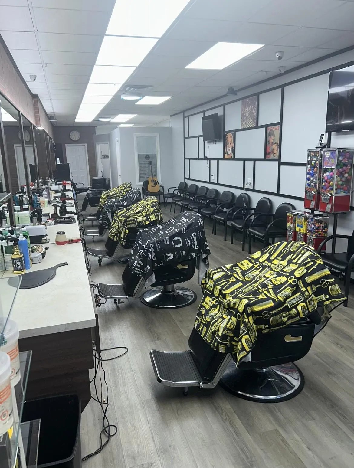 Inside Plaza Barber Shop on Hempstead Turnpike, West Hempstead, with barber chairs and mirrors down the length of the shop