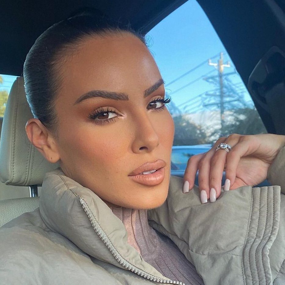 Client with sculpted cosmetic tattoo brows and full glam makeup