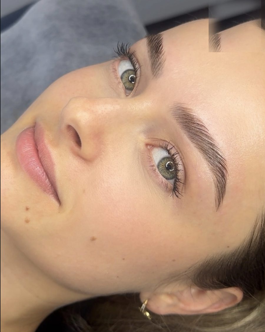 Blonde client with full laminated brows photographed in natural light