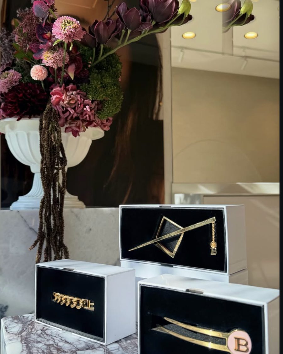 Flowers and branded brow tools displayed in the studio window